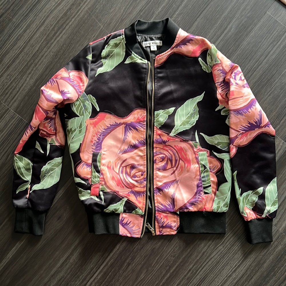 SAY WHAT? Black bomber jacket with green/pink floral pattern.